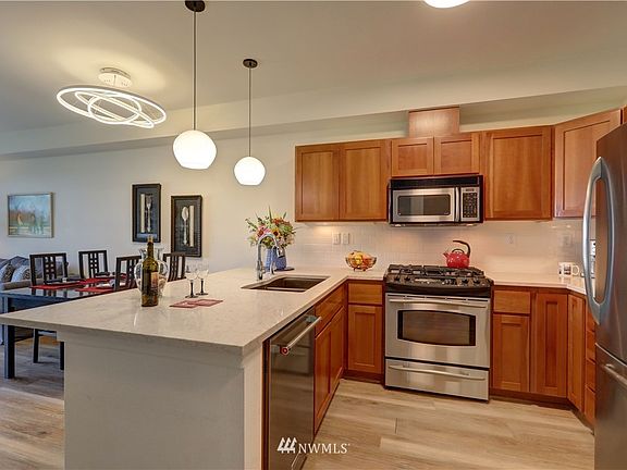 Updated lighting, quartz counter tops, subway tile backsplash and all stainless steel appliances stay.
