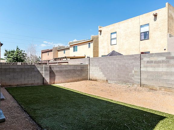 Large cute backyard with patio, shaded in evening.