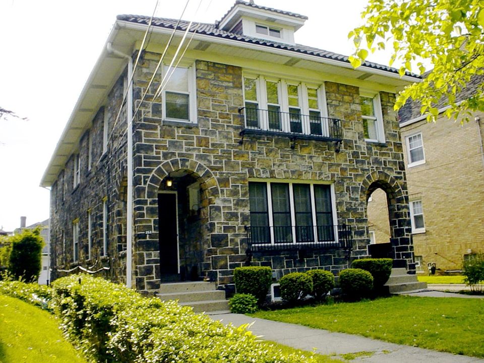Duplex. Outside. Beautiful and solidly built. All stone and Spanish tile. Doubly insulated. The advertised apartment is on the second floor. The windows seen here are in the sunroom which runs along the width of the building.