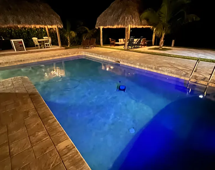 Inground lit pool at night