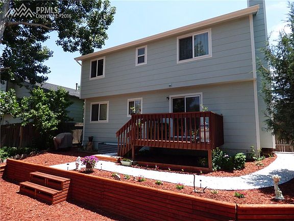 Back yard with two tiered landscaping and beautiful flowers