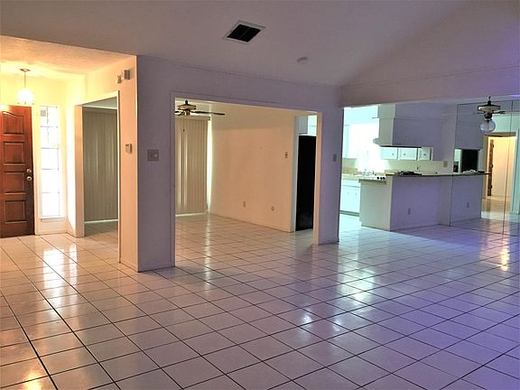 From one corner of the living room, looking into the formal dining on the left, breakfast room on the right which is right outside of the kitchen