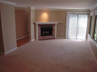 Large open great room with custom mantled fireplace and views of the greenbelt