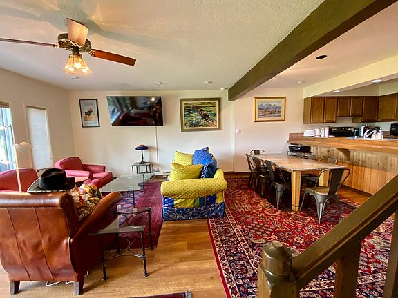 Main floor living room and dinning table with 8 chairs