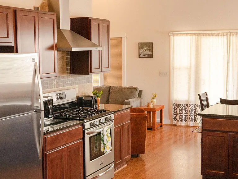 Large open kitchen with large fridge, gas range, dishwasher, dual basin sink. Full kitchen is equipped with everything you'll need.
