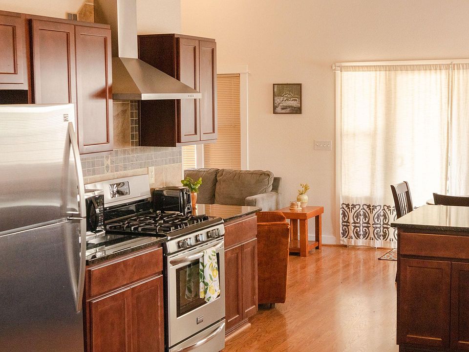 Large open kitchen with large fridge, gas range, dishwasher, dual basin sink. Full kitchen is equipped with everything you'll need.