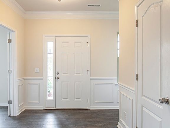 Bright foyer with Flex Rm Library, Coat Closet and Powder Room