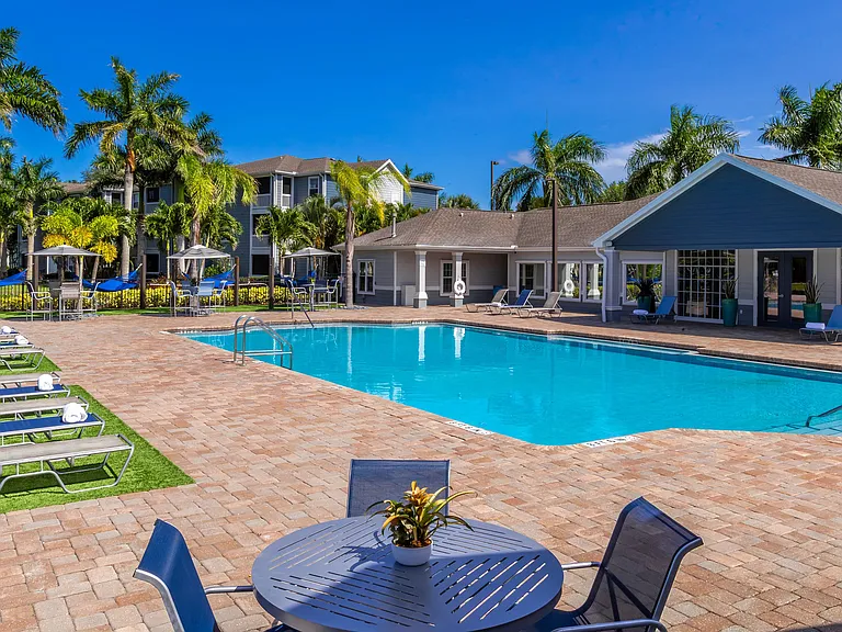 Lounge in style at our poolside retreat featuring plush sun loungers, shaded seating, and a sparkling pool just steps from your door.