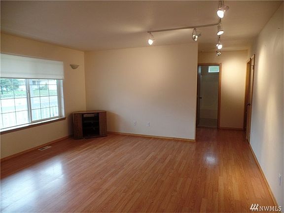 Laminate floors extend down hallways to bath and bedrooms.