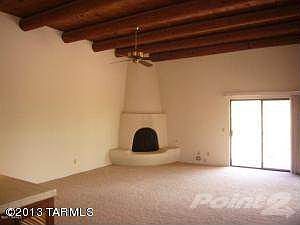 Living rm with beam ceilings & fireplace