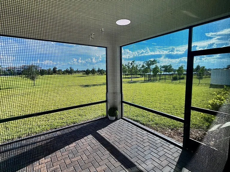 EXTRA LARGE FULL SCREENED IN PORCH WITH VIEWS OF MILE LONG LAKE AND EXPANSIVE GREENSPACE