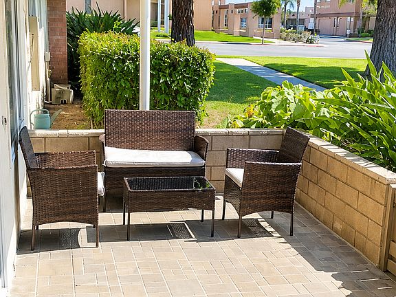 Private front patio with seating area, greenery, and a quiet outdoor space to relax.