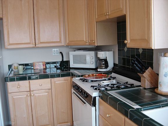 The dark green and white counter tile is striking.