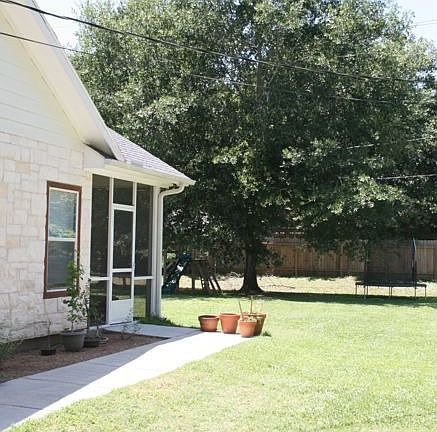 Side yard and walk leading to huge screened porch