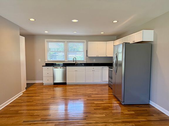 Open kitchen with white shaker cabinets and stainless appliances!