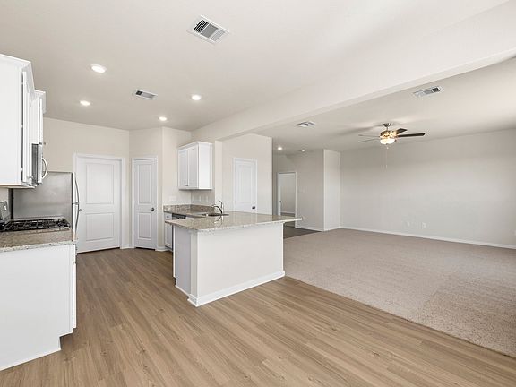 This open concept floor plan has the kitchen open to the family room.