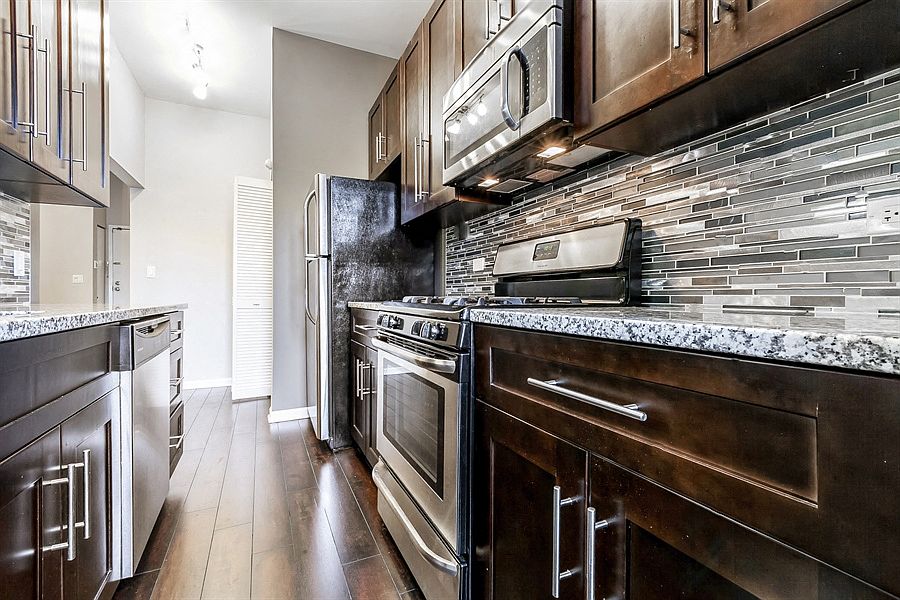 Updated kitchen with granite counter top and stainless steel appliances