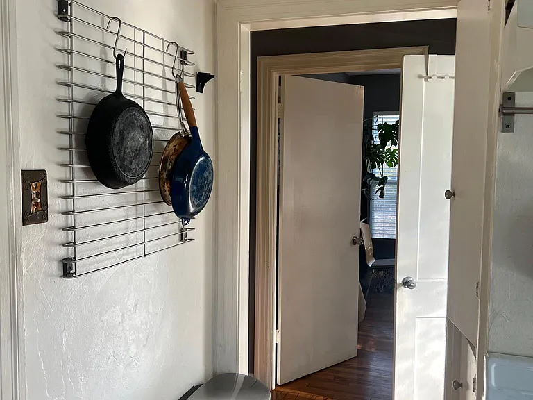 view leaving the kitchen toward bathroom and bedrooms. Pantry on the right.