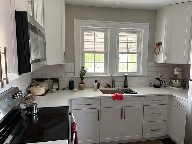 Kitchen from a recent remodel in the same building. Will have the same cabinets and quartz counters and new appliance package