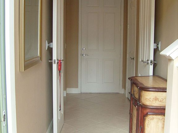 Entrance of the house w/door leading to attached garage