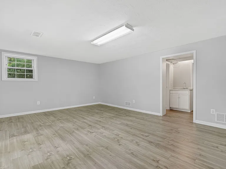 bottom floor - possible in-law suite - living room / den - doorway to wet bar and utility room