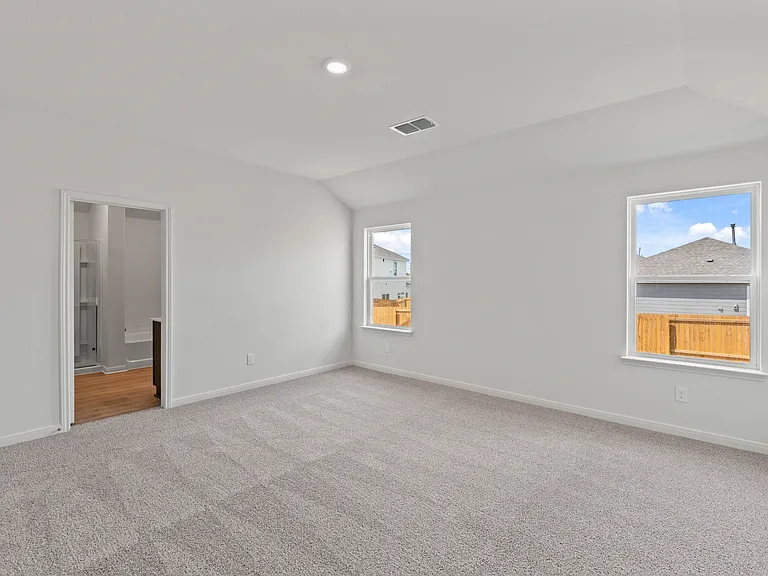 The master suite has a spacious bedroom, en-suite bathroom and walk-in closet.