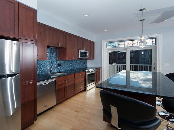 Kitchen area, island, doors to balcony