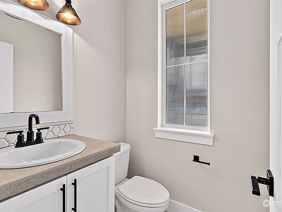 Powder Bath: Photos are of another 2200 Plan built at a different Harbour Homes community.  Colors & details will vary. Ask for details>