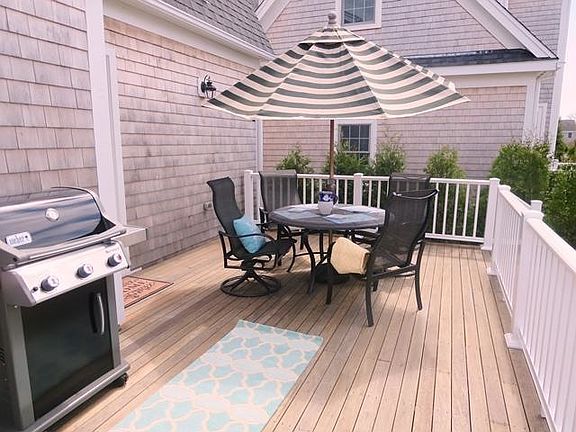 Deck with outdoor funriture- umbrellas for shade and gas bar