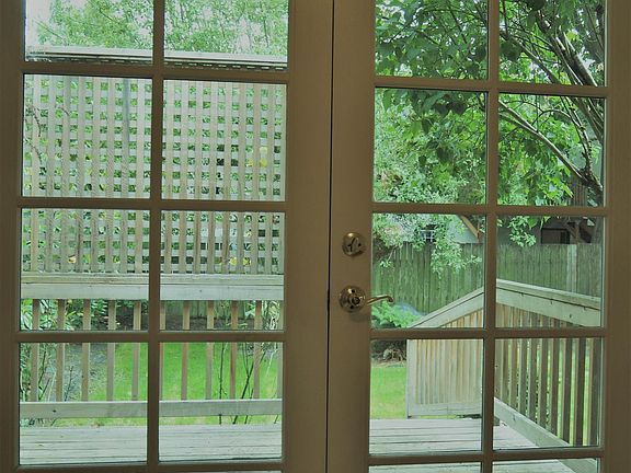 French doors lead from master bedroom to deck and yard.