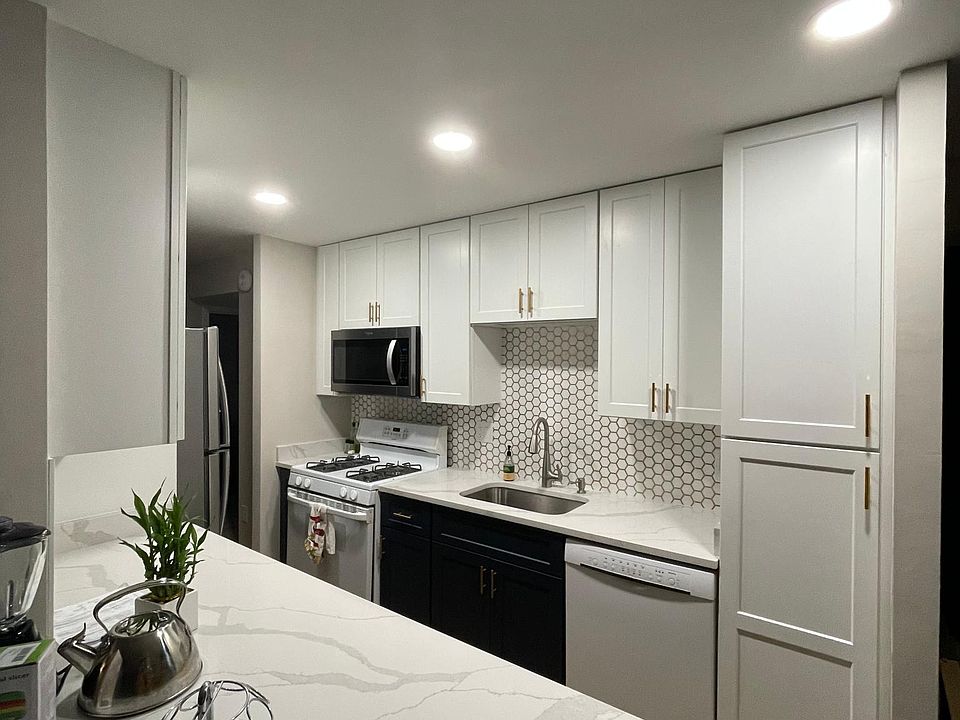 Newly remodeled quartz countertop, all new shaker style cabinets, space for countertop seating