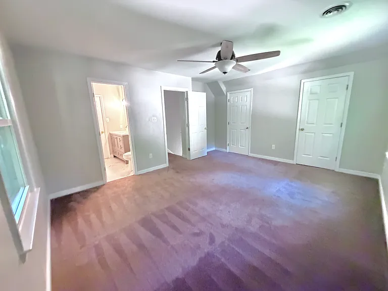 Bedroom 4 upstairs, with ceiling fan, and extremely spacious his-and-hers full size closets!