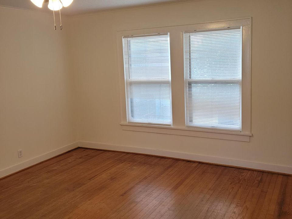 Living room overlooking Stude Park and Downtown Houston. Windows on both ends of living room.