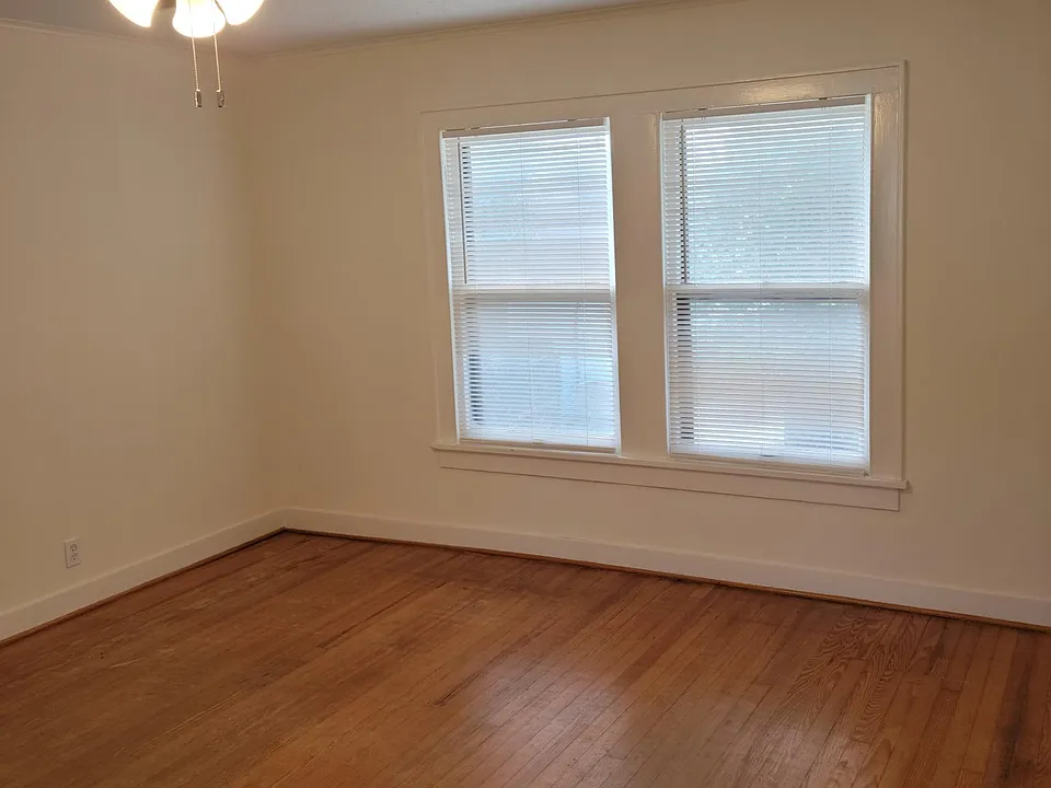 Living room overlooking Stude Park and Downtown Houston. Windows on both ends of living room.