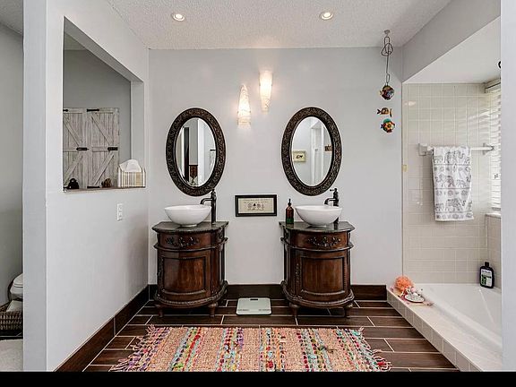 Master bathroom with two vanity, shower and bathtub.