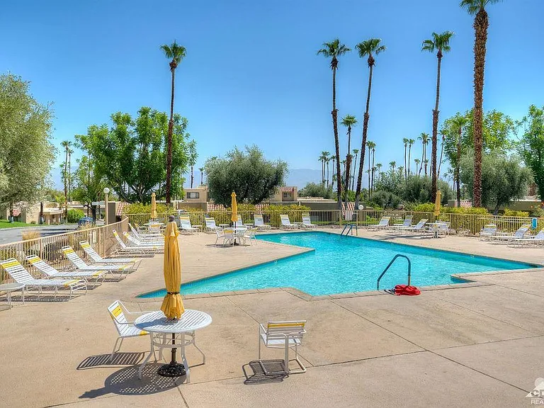 Olympic size pool next to club house, with lounging area and Jacuzzi to enjoy in all seasons
