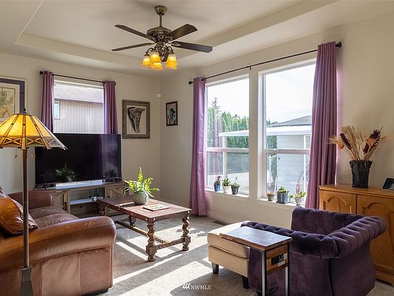 living room with coffered ceiling & ceiling fan! Notice the natural light!!! >