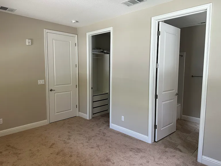Secluded 1st-floor guest suite_perfect for visitors, an in-law room featuring multiple windows, walk-in closet and attached full bath
