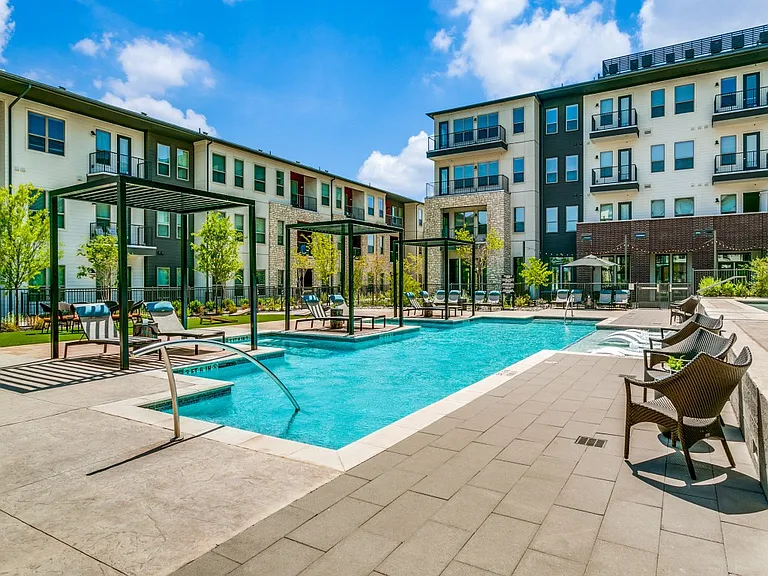 Resort-style pool and expansive sundeck with lounge seating