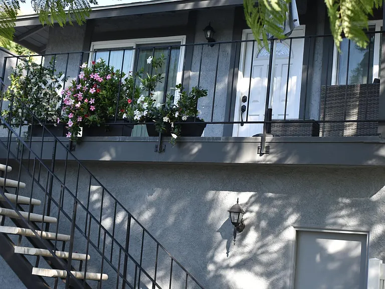 Stairway access to unit with garage entry below.
