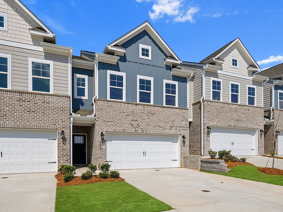 New construction townhomes with brick accents and 2-car garages at Langley Overlook in Loganville, G