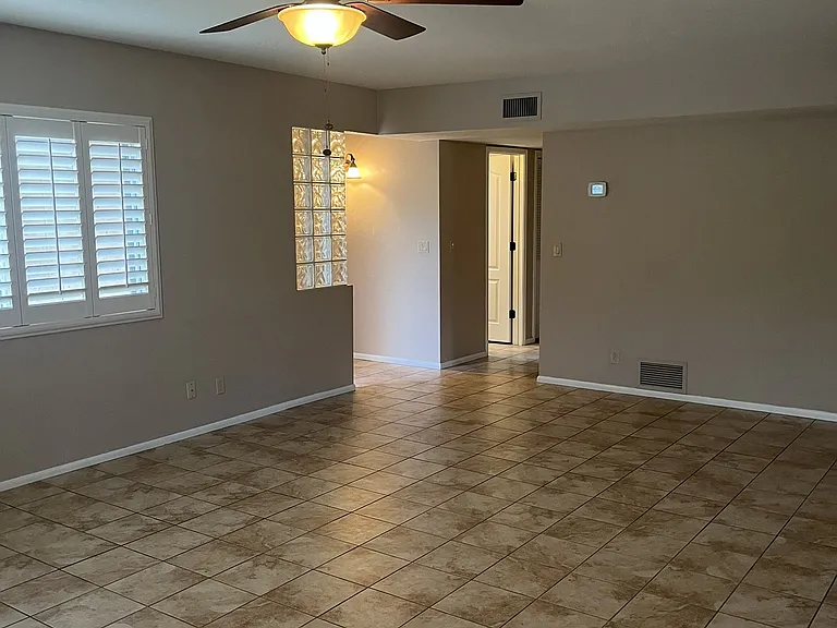 living room view to front entry way and hallway to bedrooms
