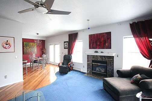 entry level livingroom, with marble gas fireplace,  view into diningroom
