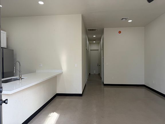 Open interior view showing the kitchen counter and hallway leading to the rest of the home.