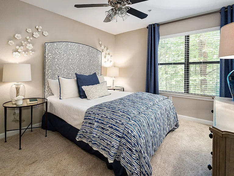 Bedroom with a window and carpeted flooring