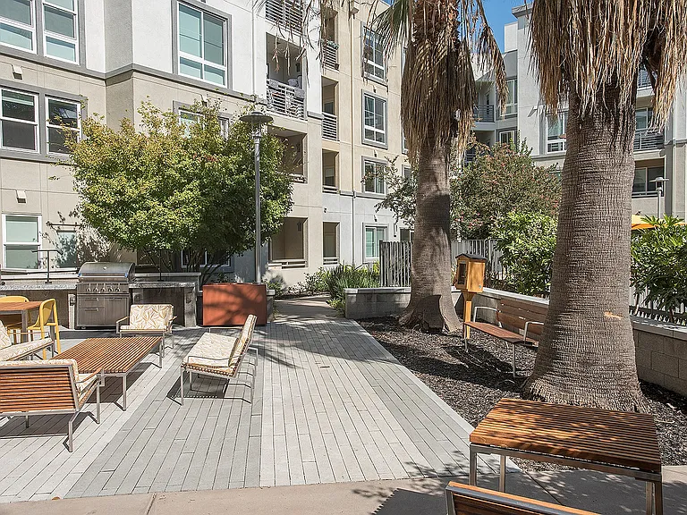 Inviting outdoor lounge with comfortable seating and lush greenery at Aster Apartments near BART.