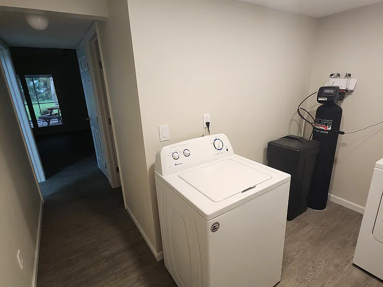 Wash Room - brand new Water Softener system. Washer and dryer ( water shutoff behind Water Softener. First level bathroom and closet/pantry on left side of hallway, bedroom 1 on right side of hallway in this picture