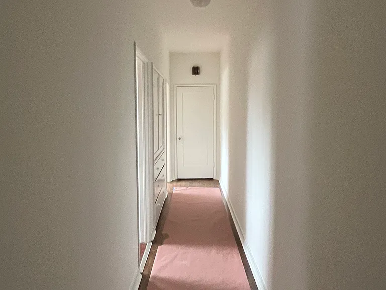 interior hallway, floors are hardwood (covered by paper for painting/remodel)
