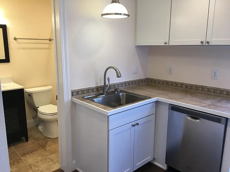 Modern kitchen amenities including stainless steel, dishwasher, garbage disposal