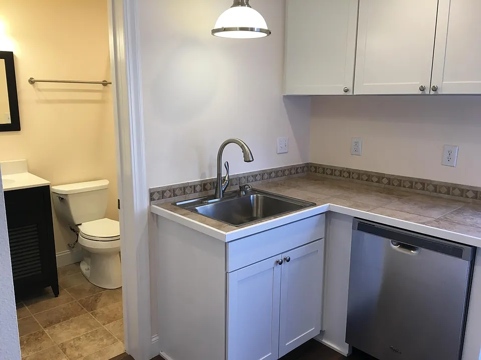 Modern kitchen amenities including stainless steel, dishwasher, garbage disposal